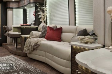 2016 Elegant Lady #5389 motorcoach interior view of side-table and sleeper sofa couch