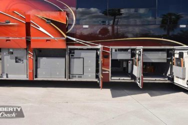 2016 Elegant Lady #5389 exterior entry side undercarriage storage bays with pull out drawers of motorcoach