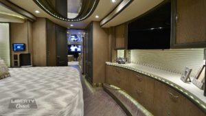 2017 Elegant Lady #5371 motorcoach interior view of bedroom shelving wall unit with TV