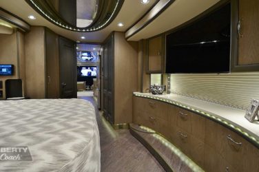 2017 Elegant Lady #5371 motorcoach interior view of bedroom shelving wall unit with TV