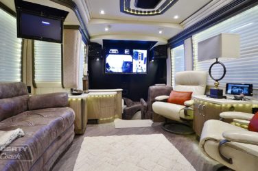 2017 Elegant Lady #5371 motorcoach interior front look view of sitting area and cockpit with TV displayed