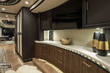 2018 Liberty Coach #897-A motorcoach interior front look view in bedroom qith shelves