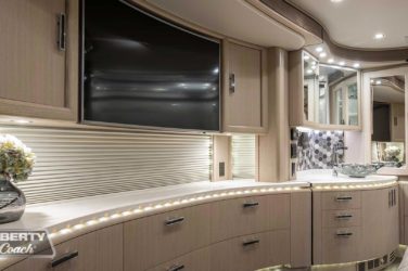 2019 Elegant Lady #7191 motorcoach interior view of bedroom shelving wall unit with TV
