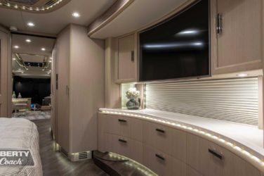 2019 Elegant Lady #7191 motorcoach interior view of bedroom shelving wall unit with TV