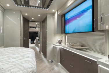 2020 Elegant Lady #860 motorcoach interior view of bedroom shelving wall unit with TV