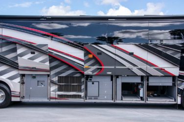 2020 Elegant Lady #7190 exterior entry side undercarriage storage bays with pull out drawers of motorcoach