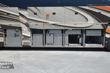 2021 Elegant Lady #5376 exterior entry side undercarriage storage bays with pull out drawers of motorcoach