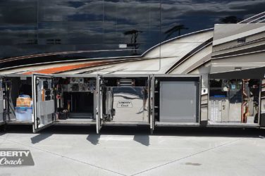 2021 Elegant Lady #5376 exterior entry side undercarriage storage bays with pull out drawers of motorcoach