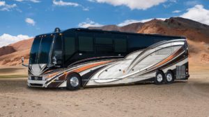 2021 Elegant Lady #865 exterior driver side view of motorcoach in the desert with slides out