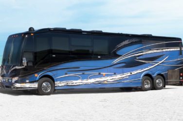 2021 Elegant Lady #866 exterior driver side front view of motorcoach on the beach