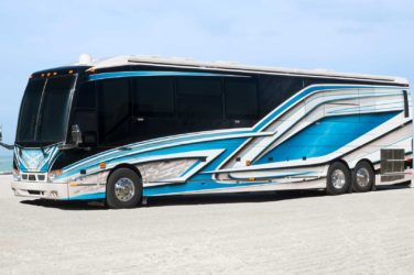 2021 Elegant Lady #867 exterior entry side front view of motorcoach on the beach