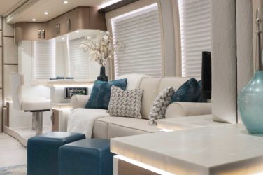 2021 Elegant Lady #867 motorcoach interior view of side-table and sleeper sofa couch
