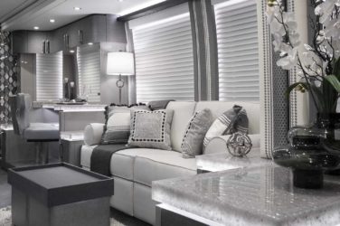 2021 Elegant Lady #869 motorcoach interior view of side-table and sleeper sofa couch