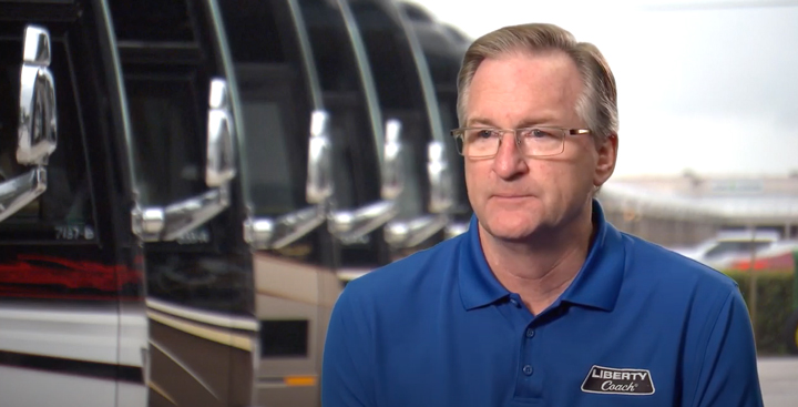 Frank Konigseder Jr. with Motorcoaches in Background