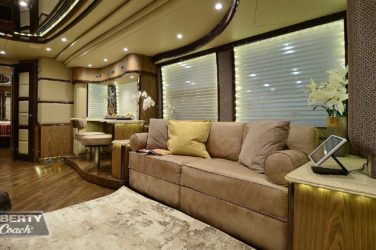 2015 Elegant Lady #5390 motorcoach interior view of side-table and sleeper sofa couch