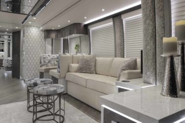 2021 Elegant Lady #872 motorcoach interior view of side-table and sleeper sofa couch