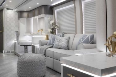 2021 Elegant Lady #874 motorcoach interior view of side-table and sleeper sofa couch