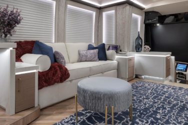 2021 Elegant Lady #876 motorcoach interior view of side-table and sleeper sofa couch