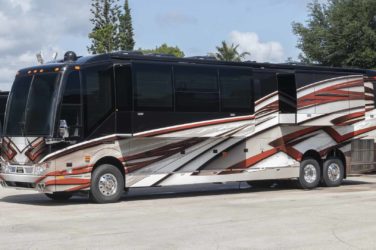 2022 Elegant Lady #878 exterior driver side view of motorcoach on the lot with slides out