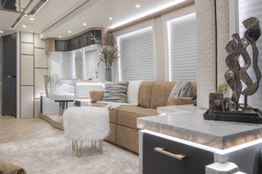 2022 Elegant Lady #878 motorcoach interior view of side-table and sleeper sofa couch