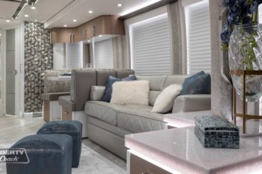 2022 Elegant Lady #881 motorcoach interior view of side-table and sleeper sofa couch