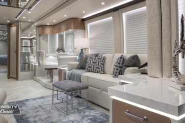 2022 Elegant Lady #882 motorcoach interior view of side-table and sleeper sofa couch