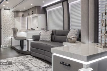 2022 Elegant Lady #883 motorcoach interior view of side-table and sleeper sofa couch