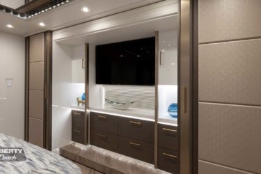 2022 Elegant Lady #884 motorcoach interior view of bedroom shelving wall unit with TV