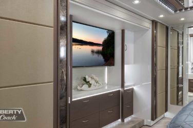 2022 Elegant Lady #885 motorcoach interior view of bedroom shelving wall unit with TV