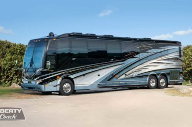 2022 Elegant Lady #885 exterior driver side front view of motorcoach on the beach