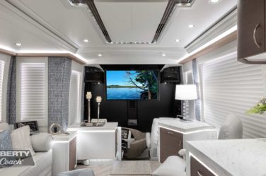 2022 Elegant Lady #885 motorcoach interior front look view of sitting area and cockpit with TV displayed