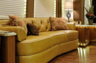 2013 Elegant Lady #5362 motorcoach interior view of side-table and sleeper sofa couch
