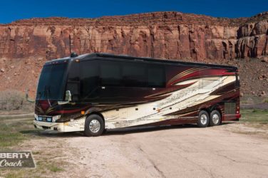 2020 Elegant Lady #7187 exterior driver side front view of motorcoach in mountain setting