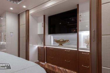 2023 Elegant Lady #893 motorcoach interior view of bedroom shelving wall unit with TV