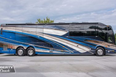 2023 Elegant Lady #894 exterior entry side view of motorcoach on the lot