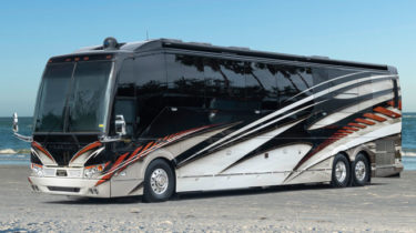 Elegant Lady motorcoach 897 parked on a beach