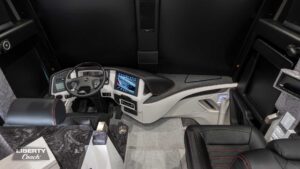 2023 Liberty Coach #899 motorcoach interior cockpit and dashboard area from behind driver’s seat