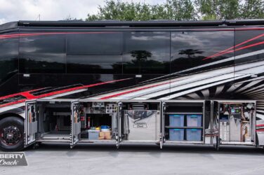 2023 Liberty Coach #899 exterior entry side undercarriage storage bays with pull out drawers of motorcoach