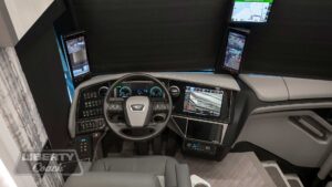 2024 Liberty Coach #901 motorcoach interior cockpit and dashboard area from behind driver’s seat